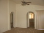 Turning slightly to the right, another view of the living room with entry to the master and sliding door to the backyard in view.