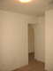 View of the second bedrrom to the arched entry-way leading to the living room.